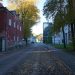 Quiet street with old buildings and trees in autumn.